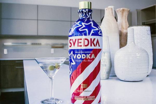 svedka vodka bottle and martine glass with 2 olives