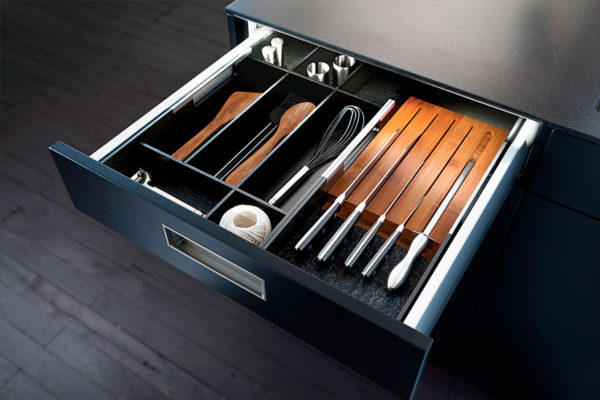 black modern cabinet open showing cooking utensils